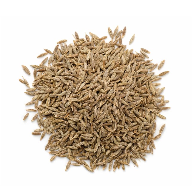 a loose circular pile of cumin seeds on a white background