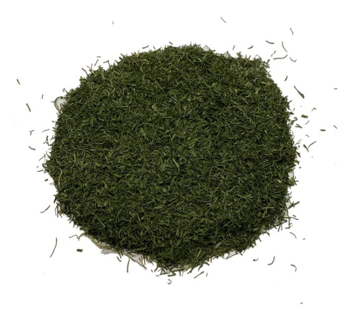 A circular pile of deep green dill tips on a white background