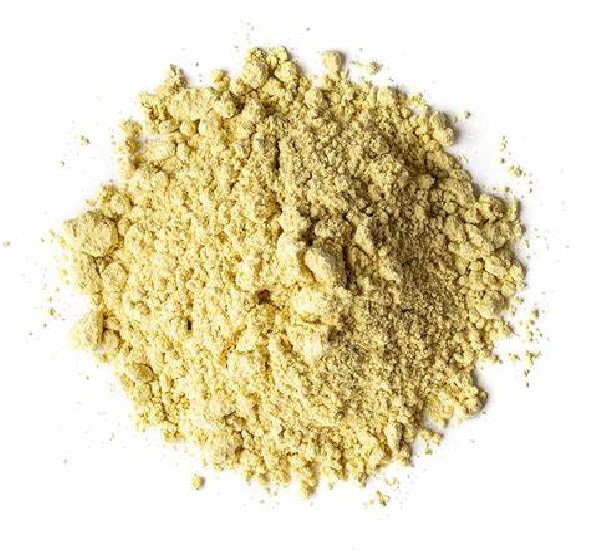 A heaped dome of light yellow fenugreek powder on a white background