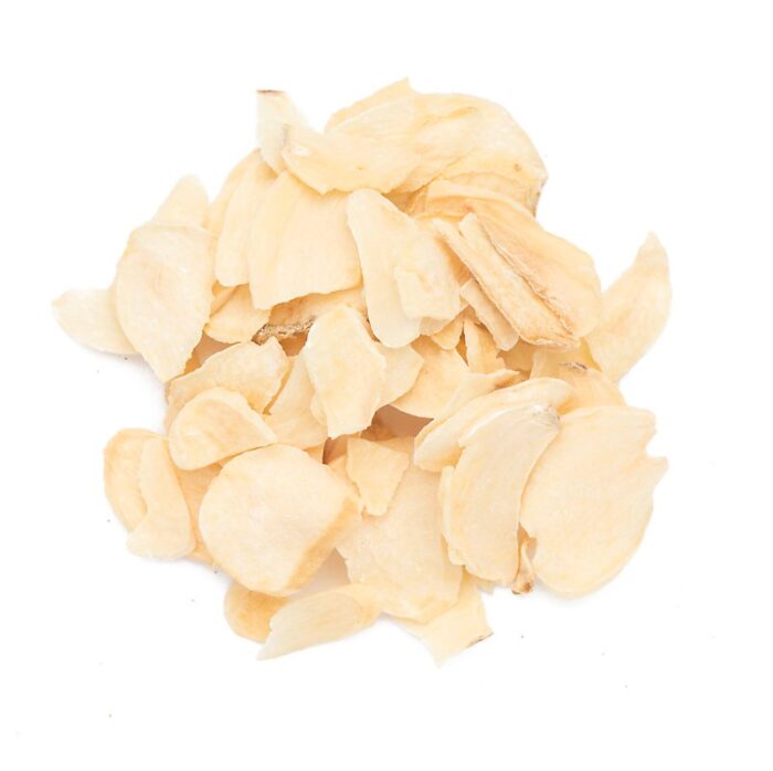 a loose circle of pale dried garlic flakes on a white background